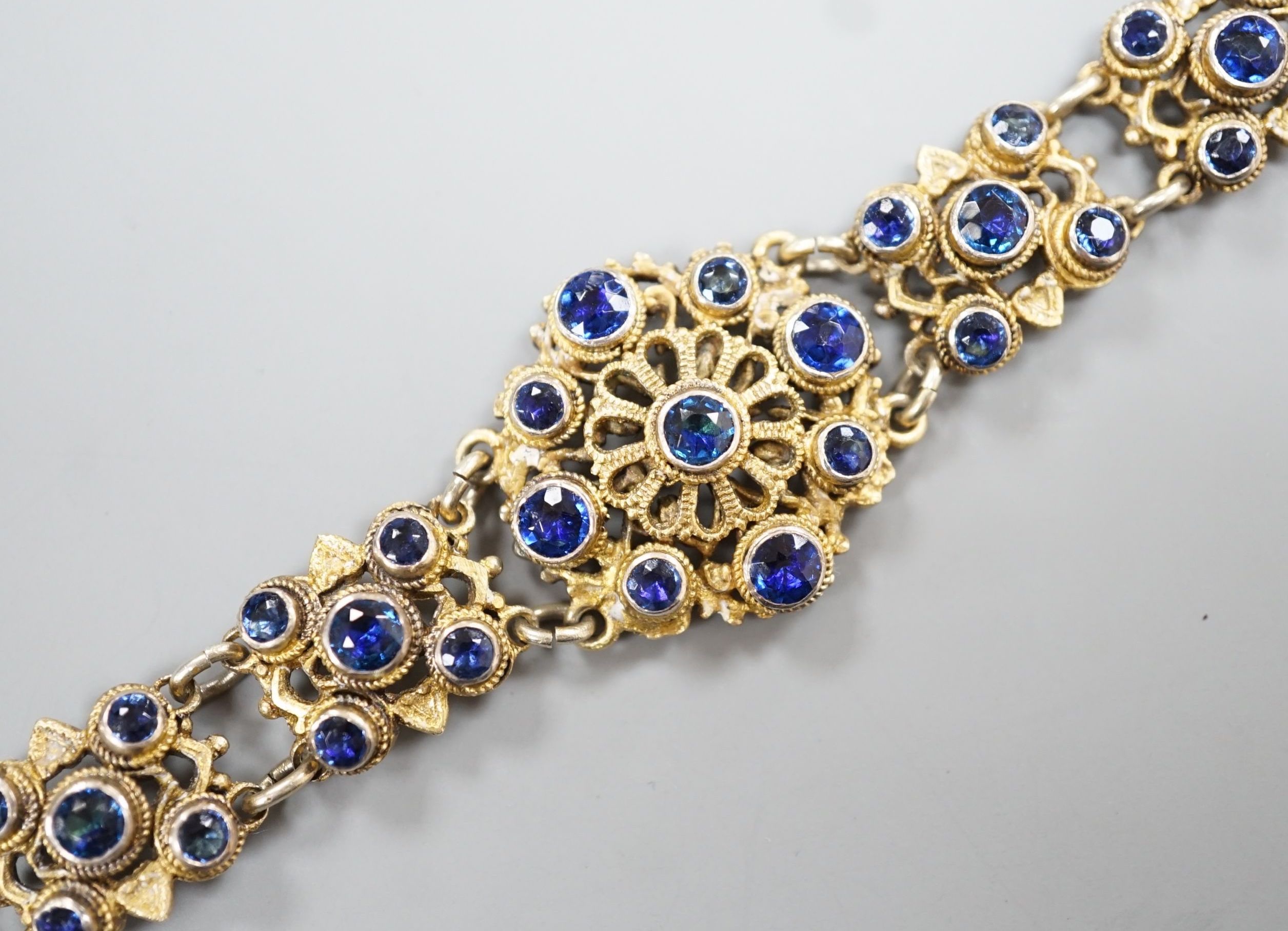 A late 19th/early 20th century Austro-Hungarian gilt white metal and blue paste set bracelet, 15.8cm.